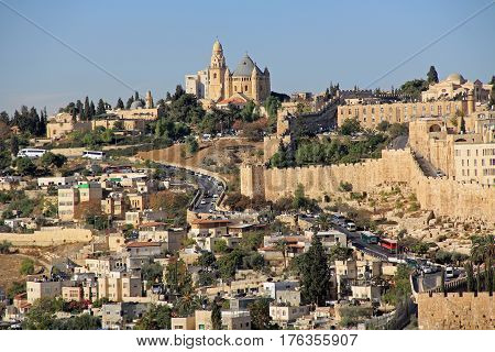 Dormition Abby and Old City Walls in a panoramic view of Jerusalem from the Mount of Olives in Israel beside the Kidron Valley.
