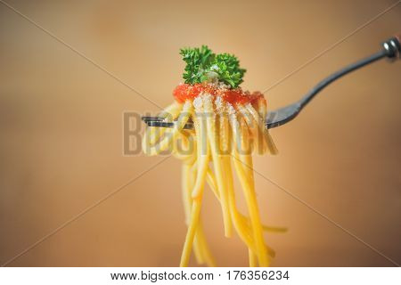 Close-up of asta spaghetti with tomato sauce olives and garnish. Italian food.