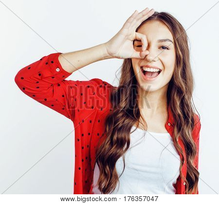 young pretty teenage hipster girl posing emotional happy smiling on white background, lifestyle people concept close up