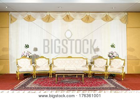 Asian indoor luxurious wedding decoration stage with golden furnitures