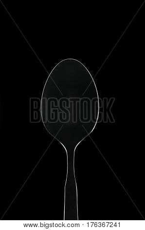 White glowing outline spoon with reflections on black background loop