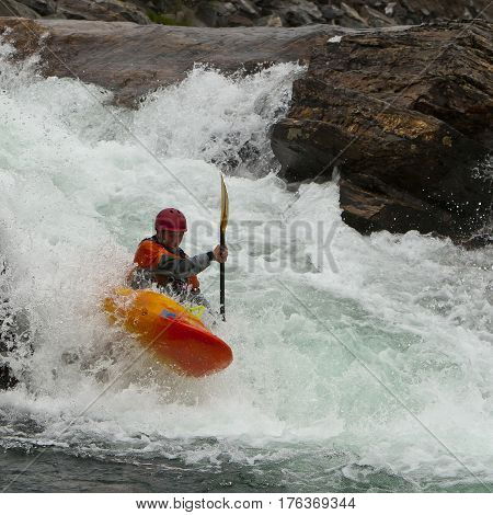 Kayaker in the waterfall in Norway Ula river