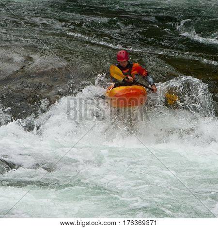 Kayaker in the waterfall in Norway Ula river
