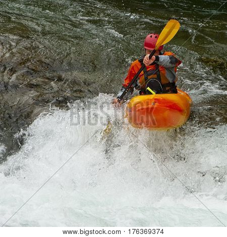 Kayaker in the waterfall in Norway Ula river