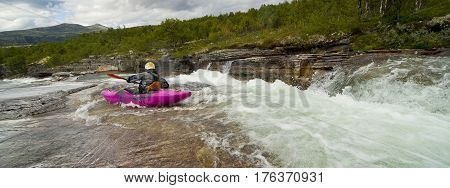 Kayaker in the waterfall in Norway Ula river