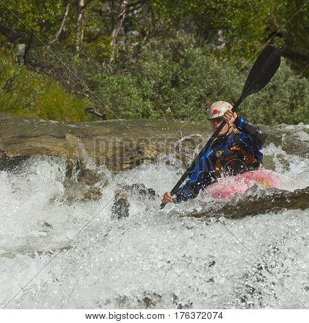 Kayaker in the waterfall in Norway Ula river