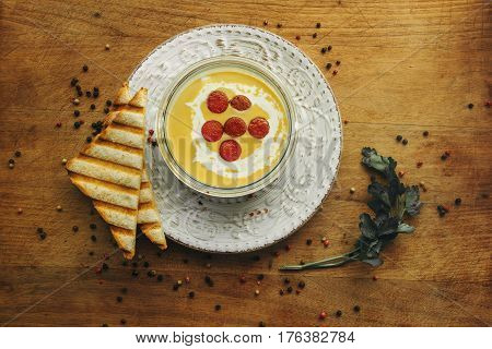 cream soup with cut sausage in the bowl. Top view