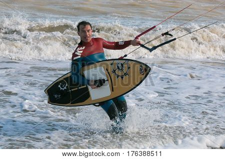 SAN BENEDETTO DEL TRONTO - MARCH 10, 2017: Tired kitesurfer go out from the sea