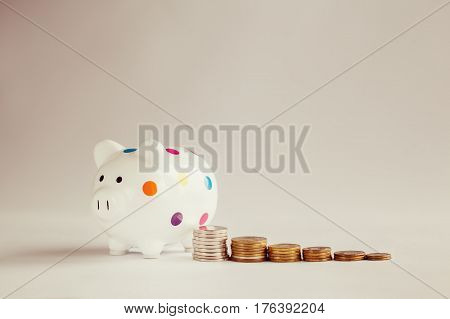 White piggy bank or money box with money coins
