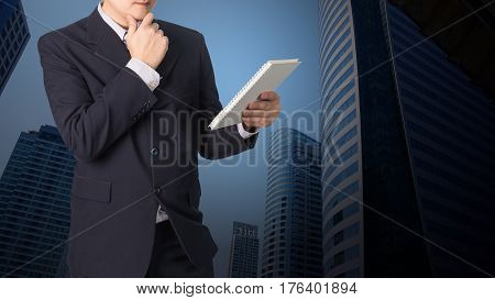Double Exposure Confident Asian Businessman Reading Notebook Or Document File With Cityscape On Blur