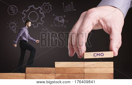 Business, Technology, Internet And Network Concept. Young Businessman Shows The Word: Cmo