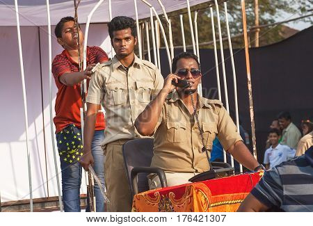 PANJIM, INDIA - FEB 25, 2017: Teenager imprisoned in a cell by actors in uniform playing corruption police department at Goa carnival on February 25, 2017. Carnaval is celebrated in Goa since 18th century