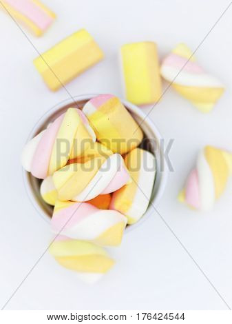 Pastel Marshmallows in white cup on white background