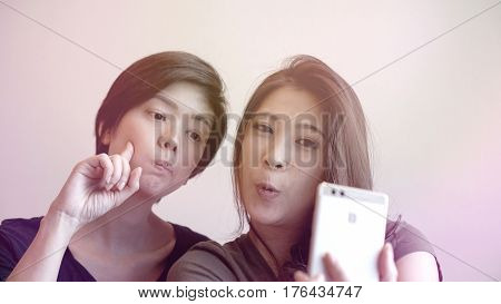 Two Happy Photogenic Asian Womans Talking Selfie With Phone