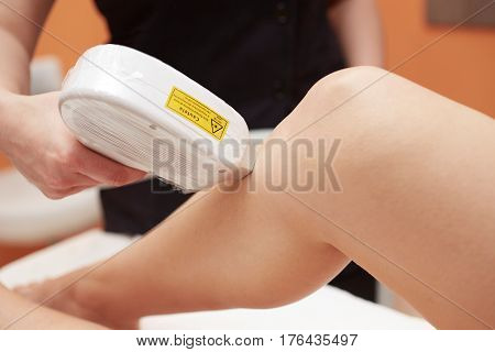 Beautician Removing Hair Of Young Woman with laser