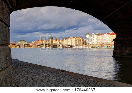 Prague Czech Republic - March 3 2017: View on the Prague panorama under the bridge after rain.The Prague bridges arching over the Vltava River are not only vital connecting links but also valuable works of architecture .
