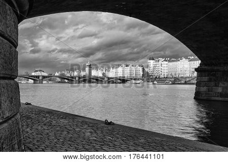 Prague Czech Republic - March 3 2017: View on the Prague panorama under the bridge after rain.The Prague bridges arching over the Vltava River are not only vital connecting links but also valuable works of architecture .