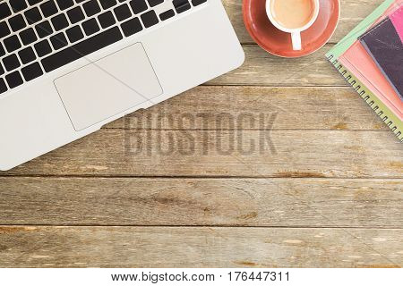 Notebooks and cup of coffee on office desk or wood table. top view with copy space for design