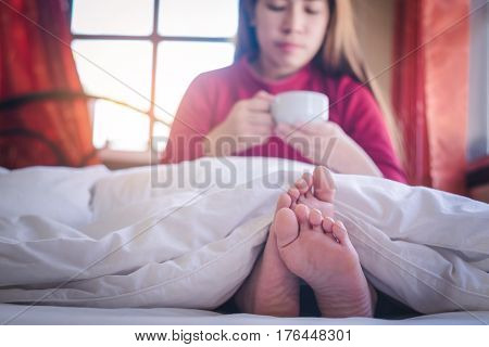Woman Relaxing and drink coffee in Bed vintage tone