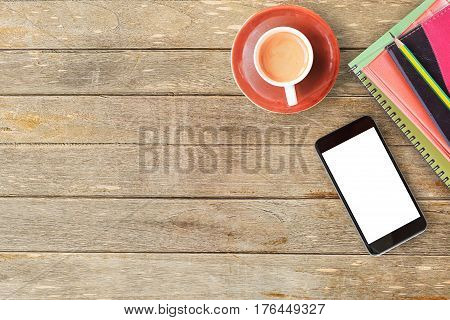 Notebooks and cup of coffee with smart phone on office desk or wood table. top view with copy space for design