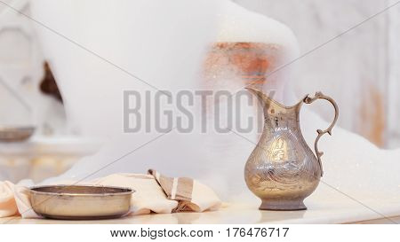 Making Soap Foam For Massage. Water Jar, Towel And Copper Bowl With Soap Foam In Turkish Hamam. Trad