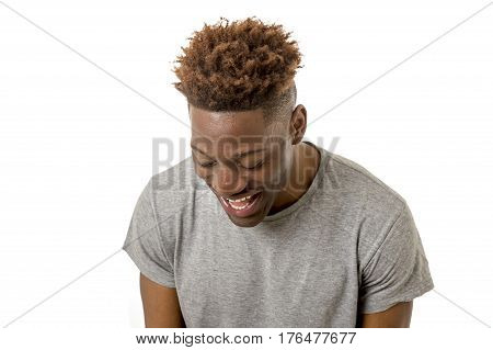close up portrait of young attractive black african american man laughing happy and excited isolated on white background