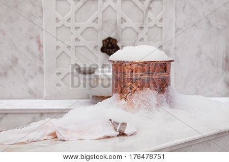 Towel And Copper Bowl With Soap Foam In Turkish Hamam. Traditional Interior Details
