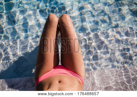 Sexy body of beautiful woman. Girl relaxing in a poll at summer
