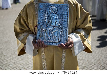 Fatima Portugal - May 13 2014: Priest holding a Holy Bible at the Sanctuary of Fatima during the celebrations of the apparition of the Virgin Mary in Fatima Portugal.