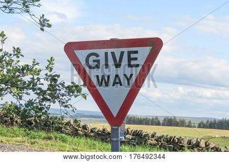 Regulatory signs give way traffic sign in the British countryside
