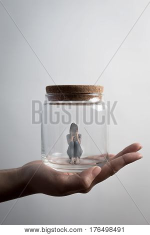 the depression woman sit imprisoned in jar
