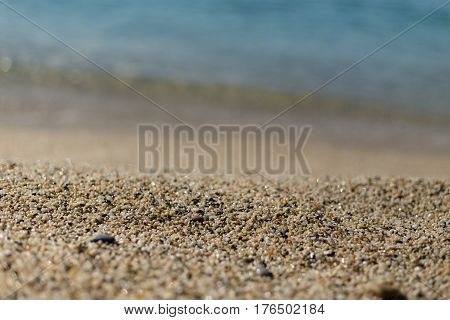 Beautiful sand at Kleopatra beach in Alanya turkey with sand in center of image in sharp focus and blurred wave and sand on foreground and background.