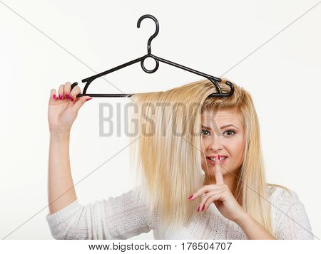 Blonde Woman Holding Hair On Clothes Hanger