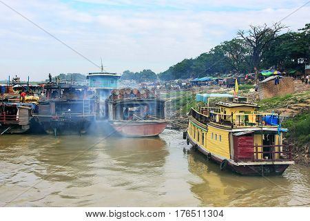 Barges anchored at Ayeyarwady river port in Mandalay Myanmar. Ayeyarwady river is the largest river in Myanmar.