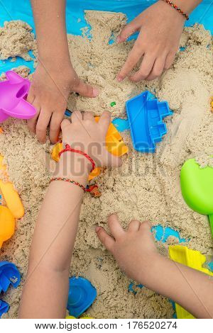 Childs Hand Close Up Playing Kinetic Sand