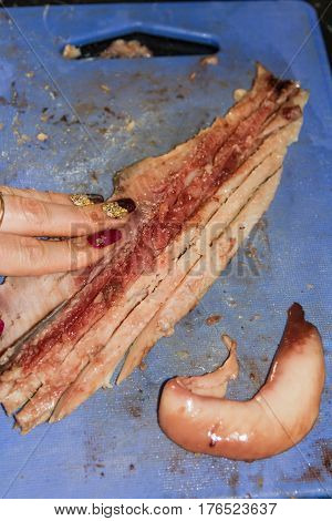 Cutting Long Strips Of Herring