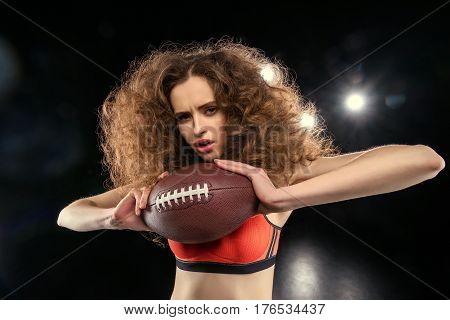 Attractive Young Sportswoman With Culry Hair Holding Rugby Ball
