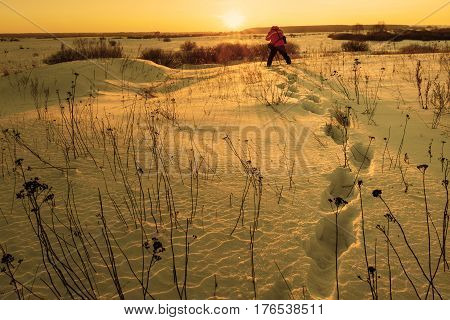 photographer takes winter landscape at dawn in the bitter cold.