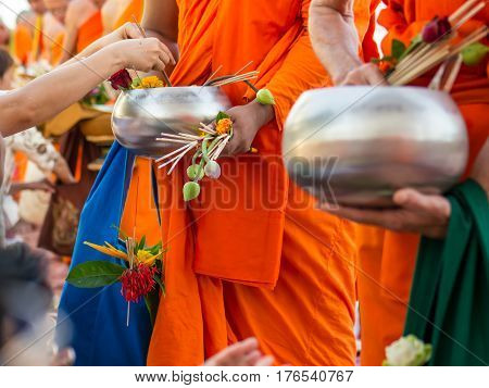 Offer sacrifice flowers to monk, Buddhist  religion