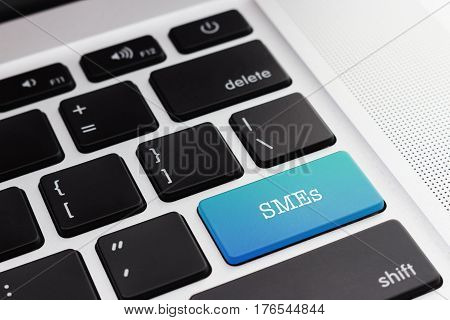 SMEs (SMALL AND MEDIUM-SIZED ENTERPRISES): Close up green button keyboard computer. Digital Business and Technology Concept.