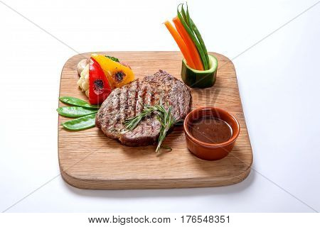 Grilled Foods - Bbq Beef Steak With Hot Sauce And Vegetables On A Wooden Board