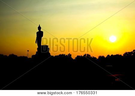 Sunset in Buddhist park in the Phutthamonthon district Buddhamonthon. Nakhon Pathom Province of Thailand. (Silhouette of Buddha)