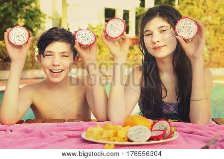Siblings Teenager Boy And Girl With Dracon Cut Fruit