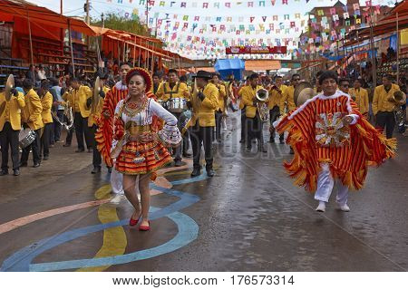 ORURO, BOLIVIA - FEBRUARY 25, 2017: Group of traditional dancers in colourful costumes parading through the mining city of Oruro on the Altiplano of Bolivia during the annual Oruro Carnival.