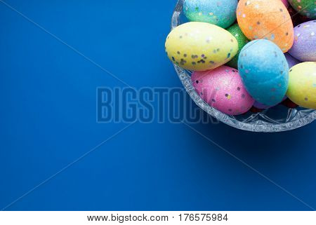Easter Eggs In A Crystal Dish On A Blue Background,