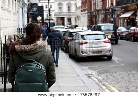 Young girl explores London with green backpack