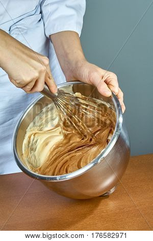 chef whips yellow cream in a bowl by hand for making cheesecakes complete series of food recipes