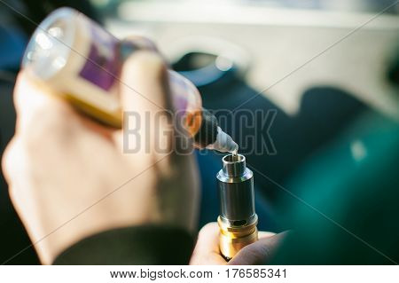 Young Vaper Man With Beard Vaping Mechanical Mod. Guy Smokes An Electronic Cigarette By Blowing A Sm