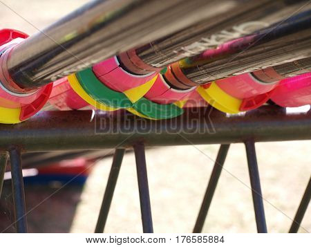 A view from the underside of the equipment rack for rowing orrs. The colorful mounts can be adjusted to set the orrs.