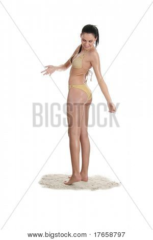 Bautiful young caucasian woman in bikini standing on sand (with sand on her body), isolated on white background